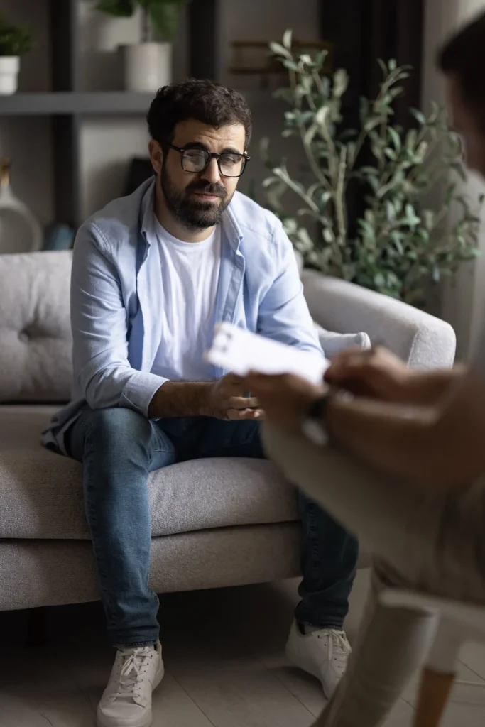 Professional sitting on a couch in a therapy session